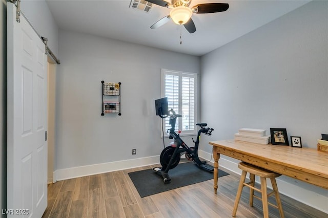 7349 Royal Melbourne Dr, Las Vegas, NV 89131 - workout room with visible vents, wood finished floors, baseboards, a barn door, and a ceiling fan