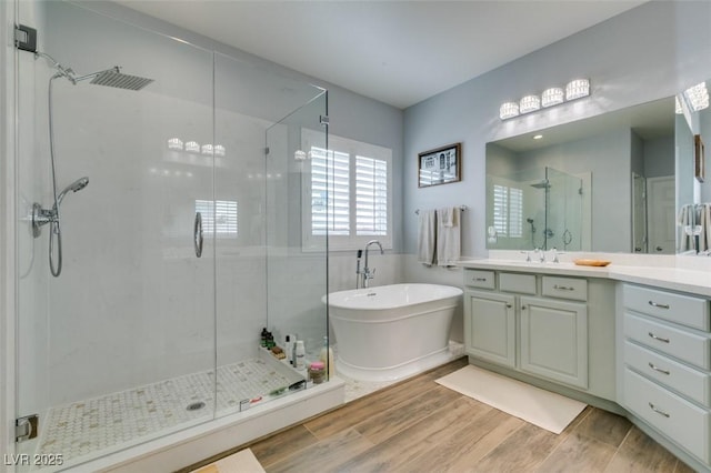 7349 Royal Melbourne Dr, Las Vegas, NV 89131 - bathroom featuring vanity, a freestanding tub, wood finished floors, and a shower stall
