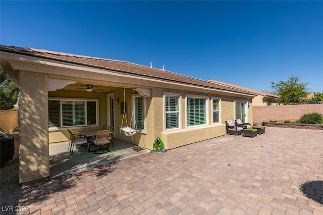 7349 Royal Melbourne Dr, Las Vegas, NV 89131 - back of property featuring fence, ceiling fan, stucco siding, outdoor lounge area, and a patio area