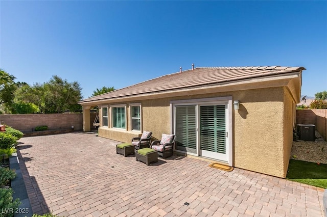 7349 Royal Melbourne Dr, Las Vegas, NV 89131 - rear view of house with a fenced backyard, a patio, stucco siding, and central AC unit