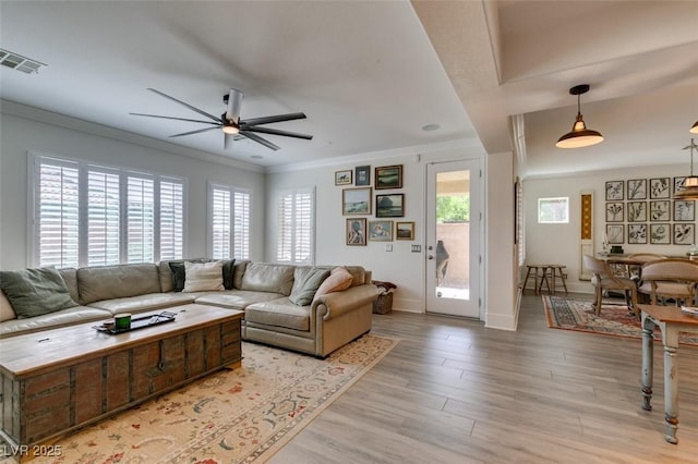 7349 Royal Melbourne Dr, Las Vegas, NV 89131 - living area with a ceiling fan, visible vents, crown molding, baseboards, and light wood finished floors