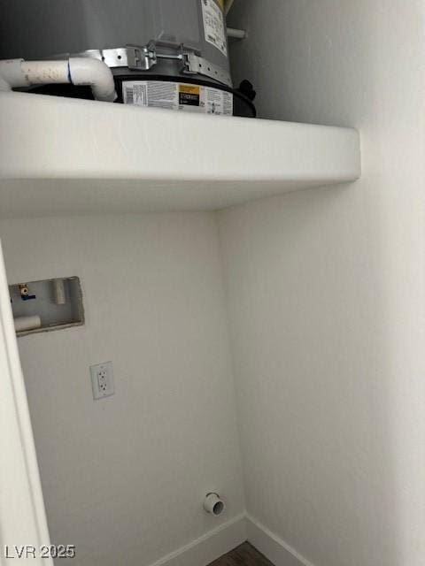 laundry room with baseboards, washer hookup, wood finished floors, and laundry area