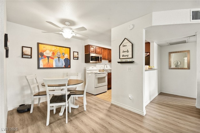 dining area with visible vents, a ceiling fan, light wood-style flooring, and baseboards
