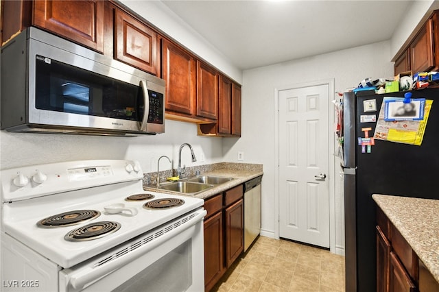 kitchen with light countertops, appliances with stainless steel finishes, and a sink