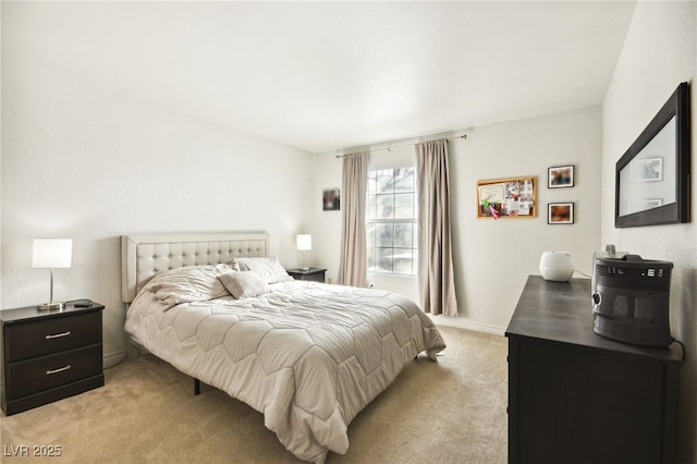 bedroom with baseboards and light carpet