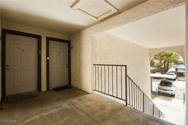 entrance to property featuring stucco siding