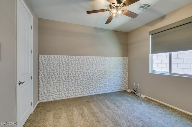 unfurnished room featuring baseboards, ceiling fan, carpet, and visible vents