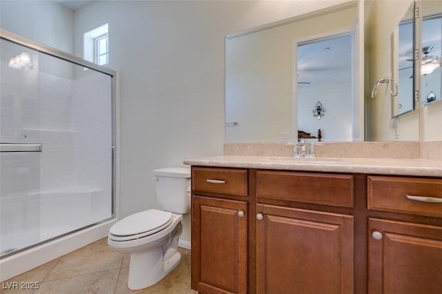 bathroom with vanity, toilet, and a stall shower