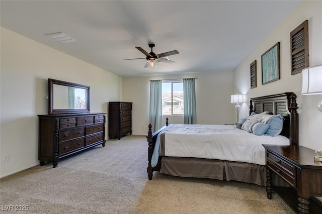 bedroom featuring light colored carpet, baseboards, ceiling fan, and visible vents