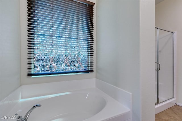 full bathroom with a bath and a shower stall