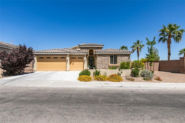 view of front facade featuring a garage, fence, stucco siding, concrete driveway, and a tile roof