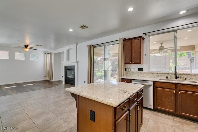 kitchen featuring stainless steel dishwasher, a ceiling fan, visible vents, and a sink