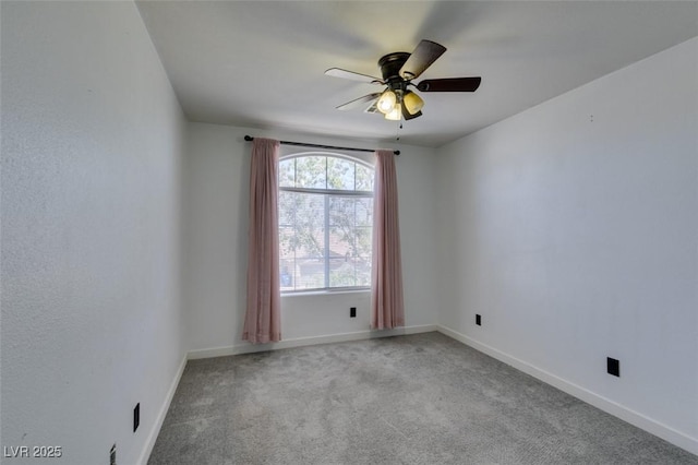 unfurnished room featuring carpet floors, baseboards, and ceiling fan