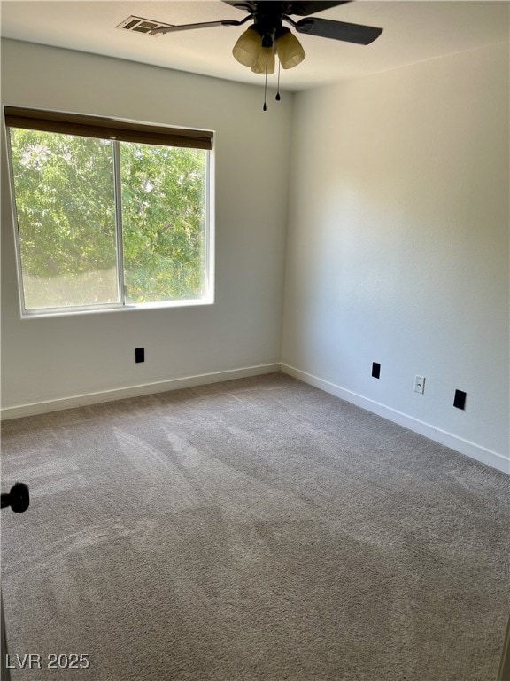 spare room with baseboards, a ceiling fan, and carpet flooring