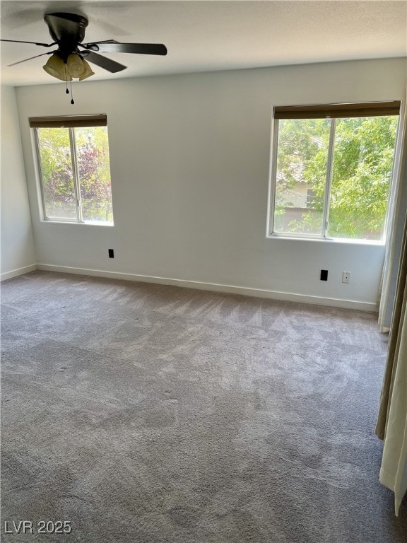 spare room featuring baseboards, carpet flooring, and ceiling fan
