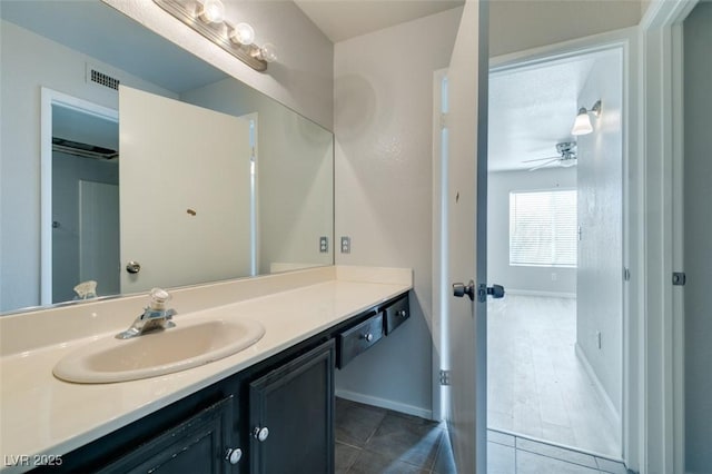 bathroom with ceiling fan, visible vents, tile patterned flooring, vanity, and baseboards