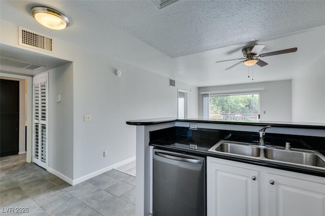 kitchen featuring dark countertops, a sink, dishwasher, a ceiling fan, and visible vents