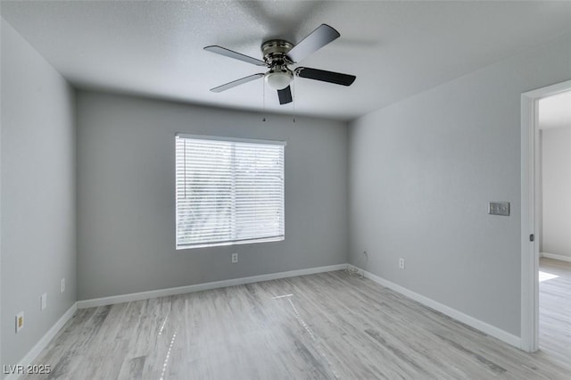 empty room featuring baseboards, ceiling fan, and wood finished floors