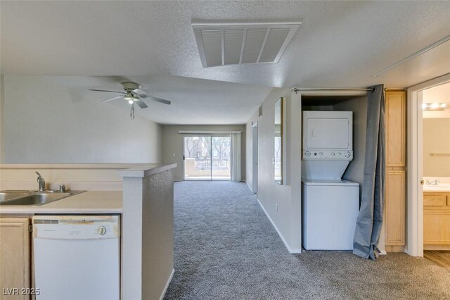 8070 W Russell Rd Unit 2121, Las Vegas, NV 89113 - kitchen featuring a sink, stacked washer / dryer, light colored carpet, visible vents, and white dishwasher