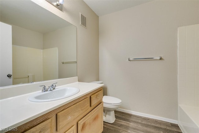 8070 W Russell Rd Unit 2121, Las Vegas, NV 89113 - bathroom featuring toilet, wood finished floors, vanity, visible vents, and baseboards