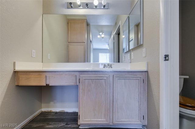 8070 W Russell Rd Unit 2121, Las Vegas, NV 89113 - bathroom featuring toilet, baseboards, vanity, and wood finished floors