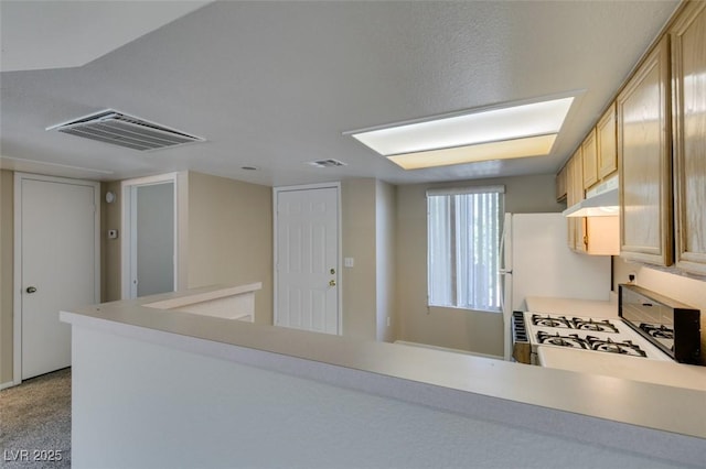 8070 W Russell Rd Unit 2121, Las Vegas, NV 89113 - kitchen featuring light countertops, white range with gas stovetop, visible vents, and under cabinet range hood