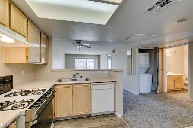 8070 W Russell Rd Unit 2121, Las Vegas, NV 89113 - kitchen featuring dishwasher, gas range oven, visible vents, a sink, and stacked washer / drying machine