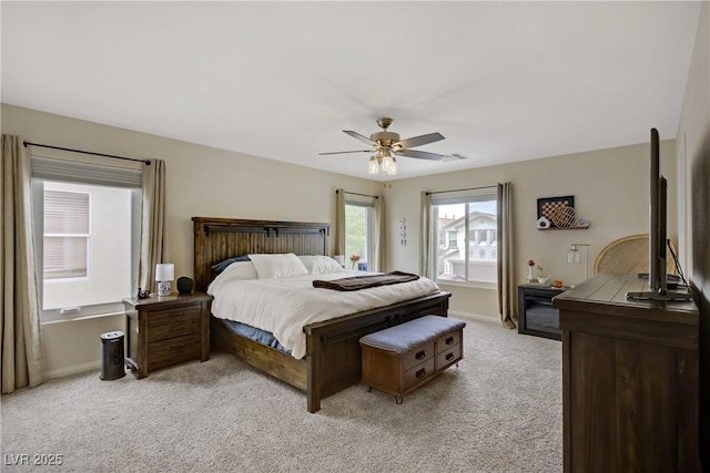 bedroom featuring baseboards, ceiling fan, visible vents, and light carpet
