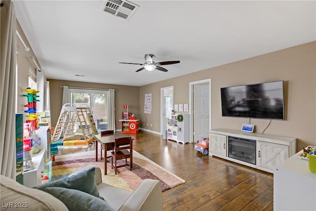 living room with baseboards, a ceiling fan, dark wood-style flooring, and visible vents