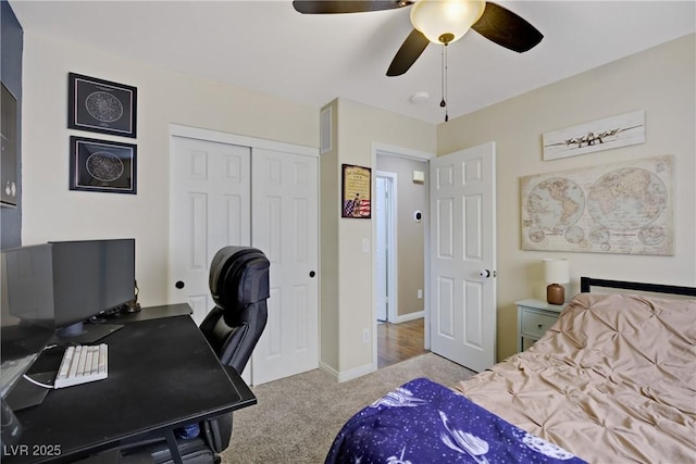 carpeted bedroom with a ceiling fan, baseboards, and a closet