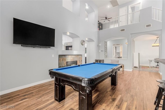 recreation room featuring ceiling fan, visible vents, and wood finished floors