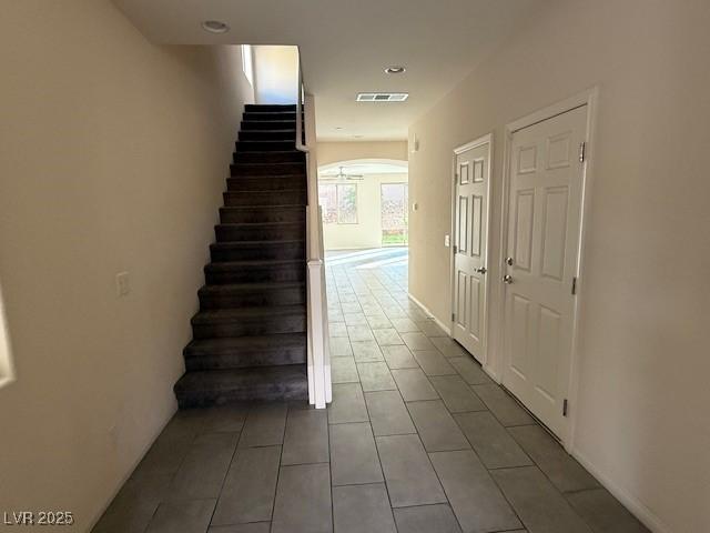2947 Caxton Grove Dr, Henderson, NV 89052 - stairs with visible vents, arched walkways, and tile patterned flooring