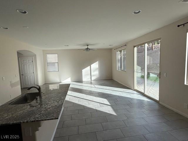 2947 Caxton Grove Dr, Henderson, NV 89052 - unfurnished living room with arched walkways, ceiling fan, recessed lighting, and a sink