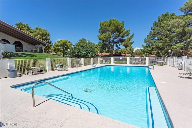 pool featuring a patio and fence