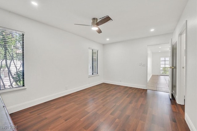 spare room with visible vents, baseboards, ceiling fan, recessed lighting, and dark wood finished floors