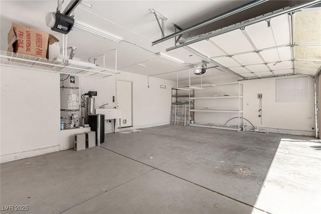 garage featuring a garage door opener and a sink
