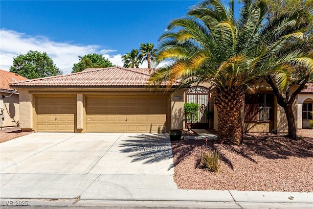 view of front of house featuring an attached garage, concrete driveway, a tile roof, and stucco siding