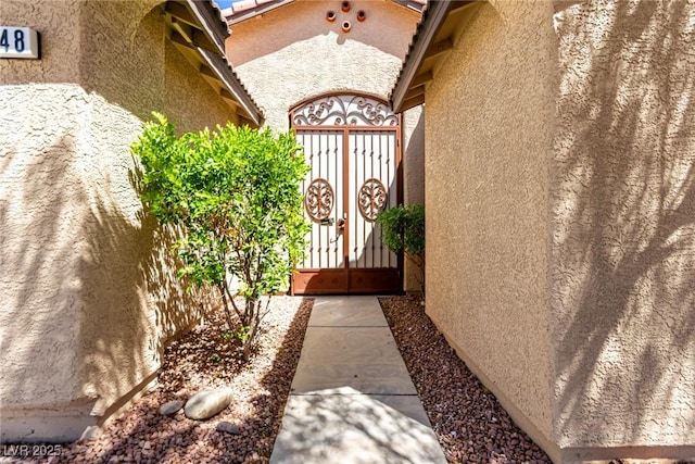 view of home's exterior featuring a gate and stucco siding