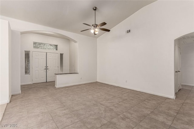 unfurnished room featuring visible vents, arched walkways, ceiling fan, and lofted ceiling