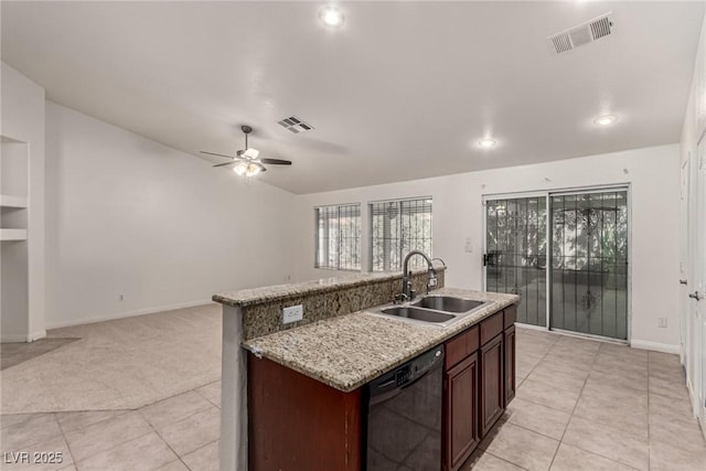 kitchen featuring light tile patterned flooring, a sink, dishwasher, open floor plan, and visible vents