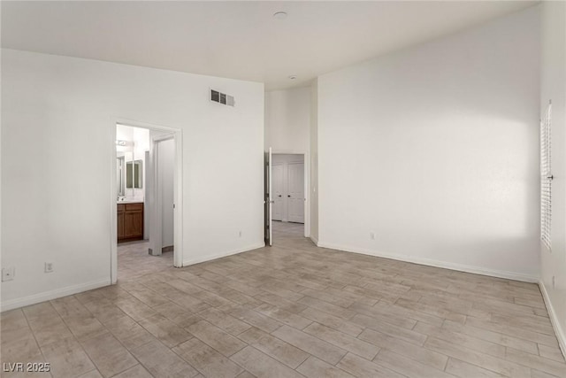 unfurnished bedroom featuring baseboards, light wood-type flooring, and visible vents