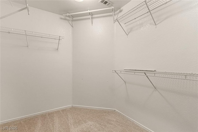 walk in closet with carpet floors and visible vents