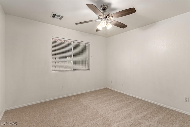 empty room featuring baseboards, ceiling fan, light colored carpet, and visible vents