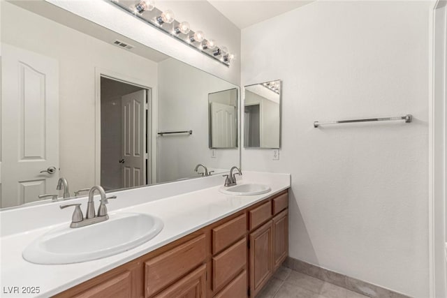full bathroom featuring visible vents, a sink, tile patterned flooring, and double vanity