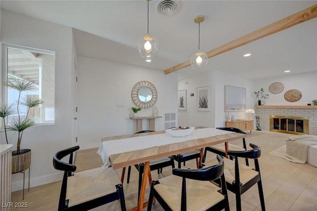 dining space with baseboards, a brick fireplace, recessed lighting, and visible vents