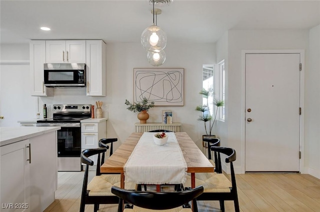 dining room featuring recessed lighting and light wood-style flooring
