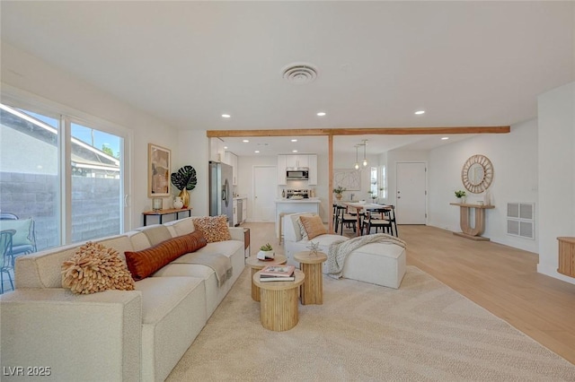 living room featuring visible vents, recessed lighting, and light wood-type flooring