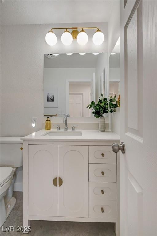 bathroom featuring toilet and vanity
