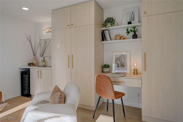 interior space with beverage cooler, recessed lighting, and light wood-type flooring
