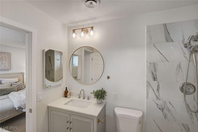 bathroom featuring vanity, a marble finish shower, ensuite bath, and toilet